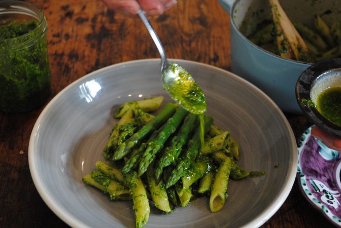 Drizzling kent cobnut pesto over pasta and asparagus