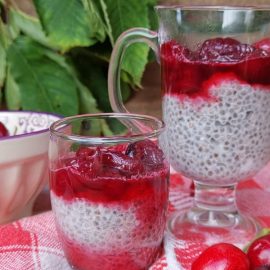 Chia coconut and cherry pudding with bowl of fresh cherries